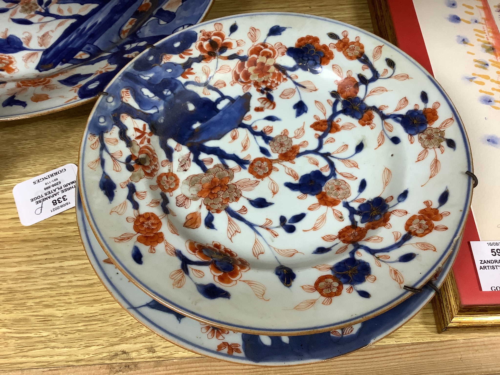 Three Japanese Imari plates together with a larger dish, 18th century, diameter 32cm